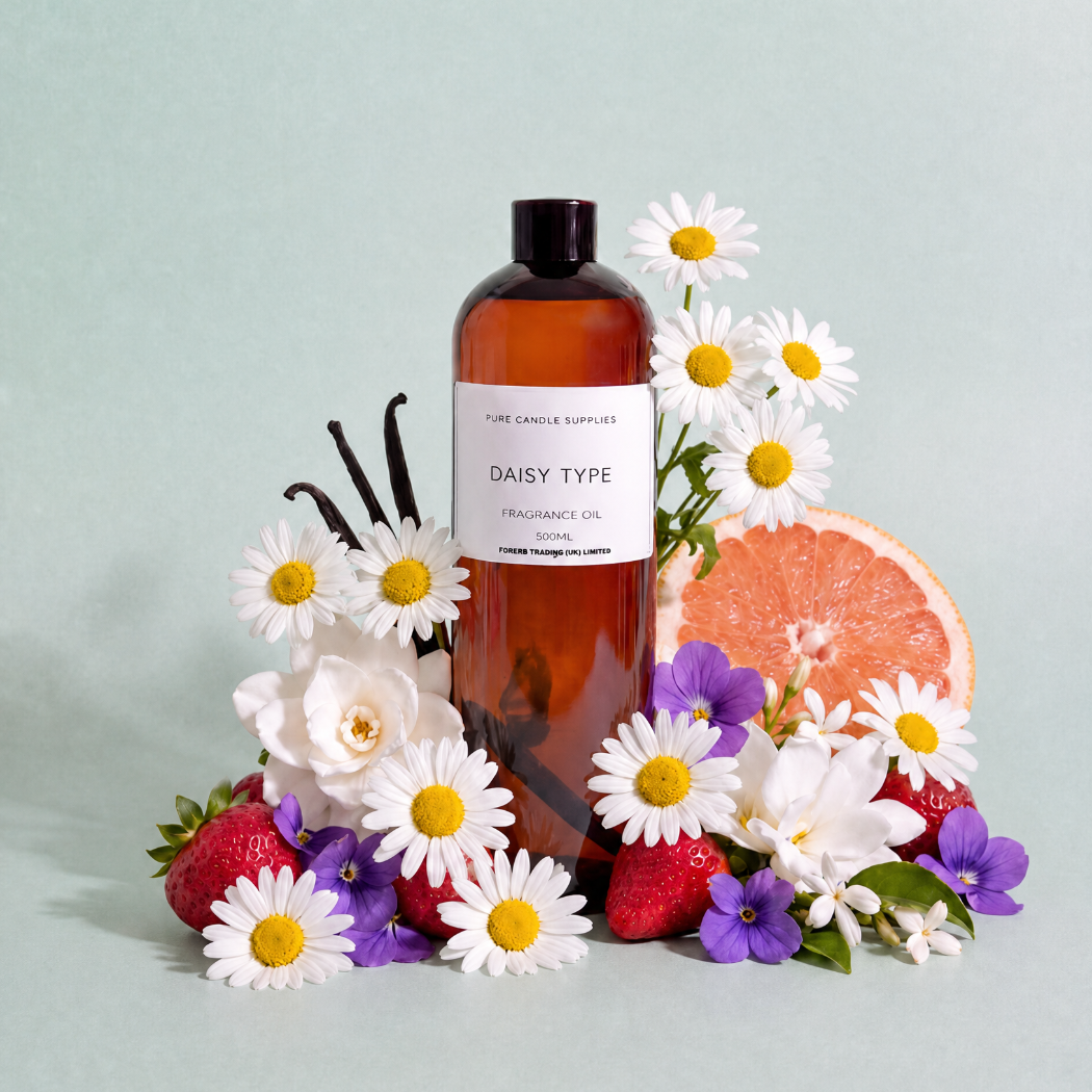 An amber glass bottle of fragrance oil labeled 'DAISY TYPE' by The Candle Supply, styled with white daisies, purple flowers, strawberries, vanilla beans, and a grapefruit slice on a pale mint background.