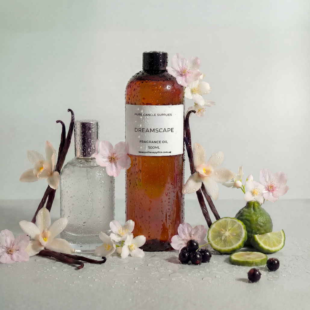 Bottle of Dreamscape fragrance oil with vanilla beans, lime, and flowers on a light background