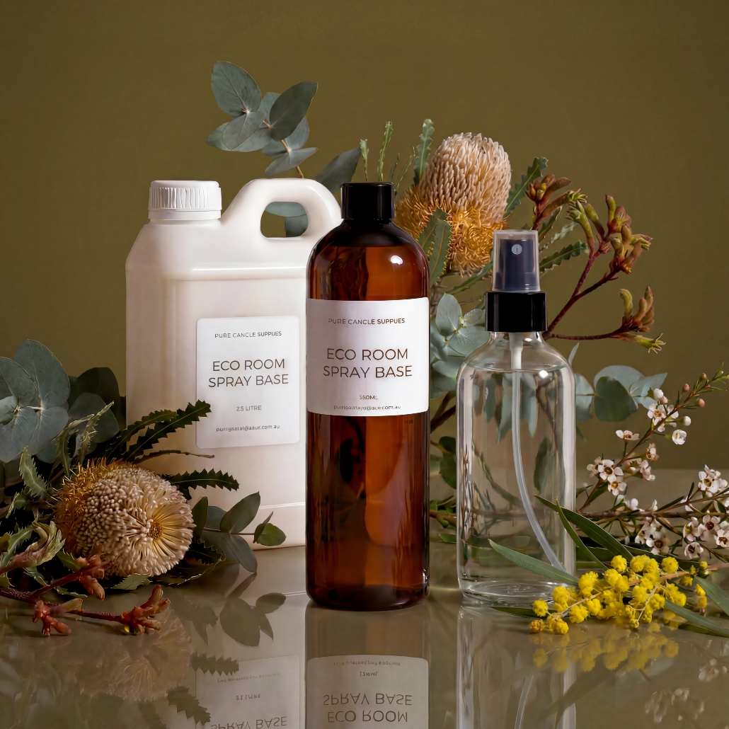 Three eco room spray bottles with labels on a reflective surface with greenery.