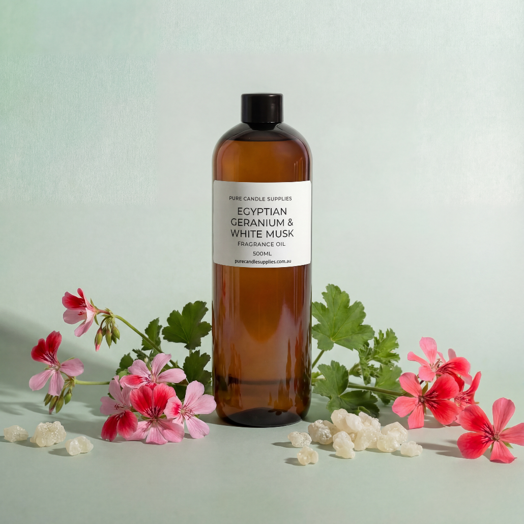 Bottle of Egyptian Geranium & White Tea fragrance oil with flowers on a light green background