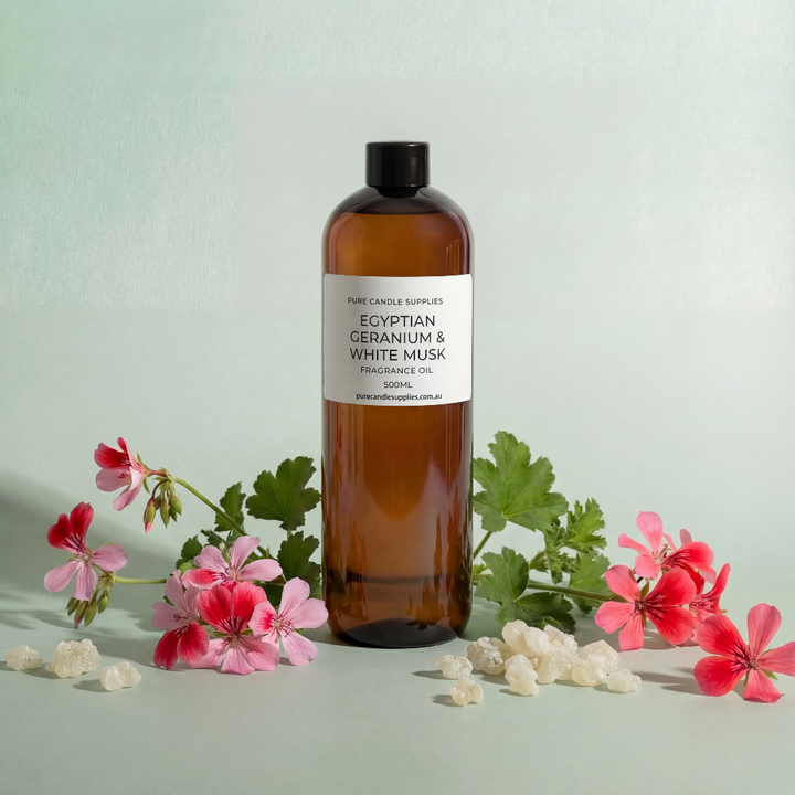 Bottle of Egyptian Geranium & White Tea fragrance oil with flowers on a light green background