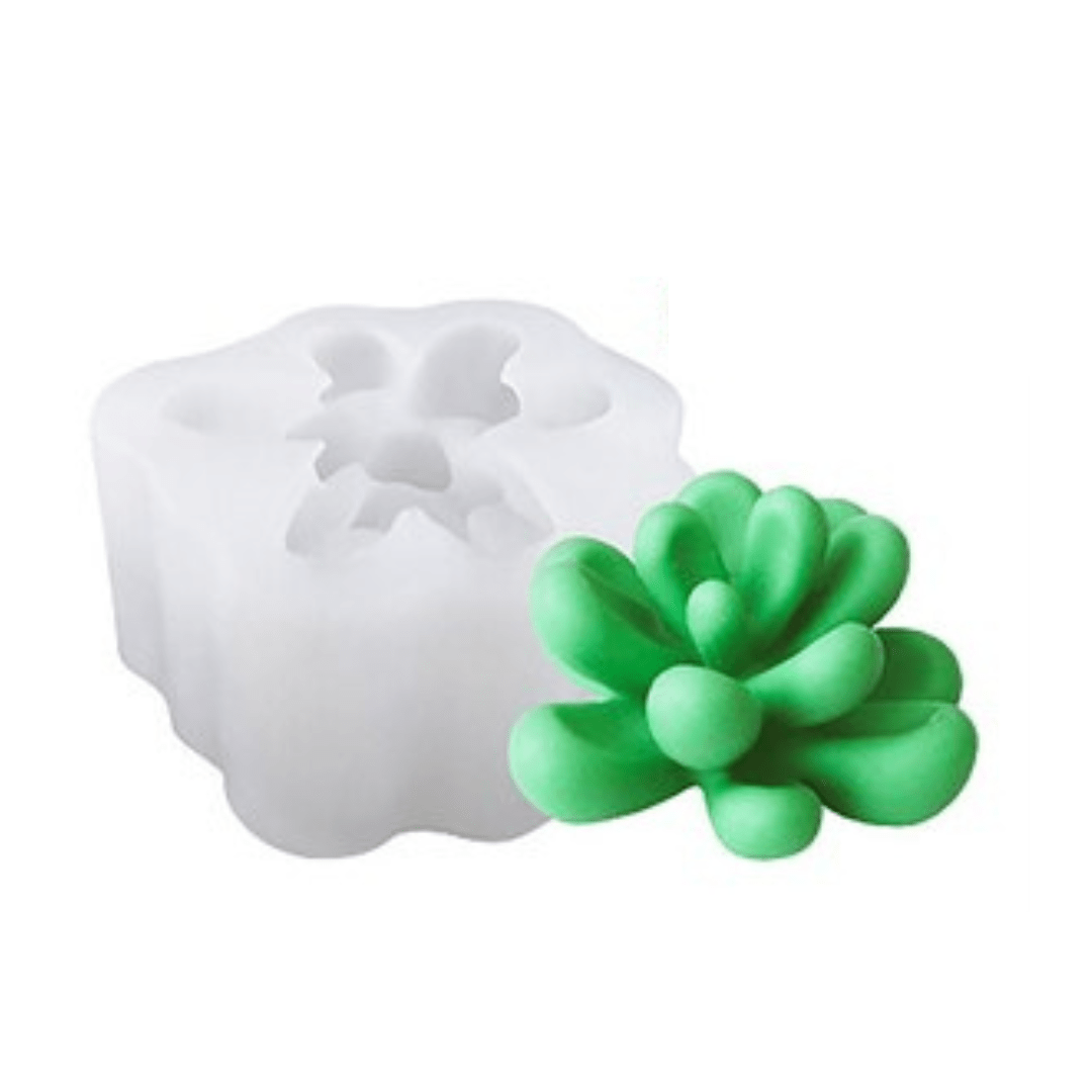flared succulent mould candle in green wax next to silicone mould on white background