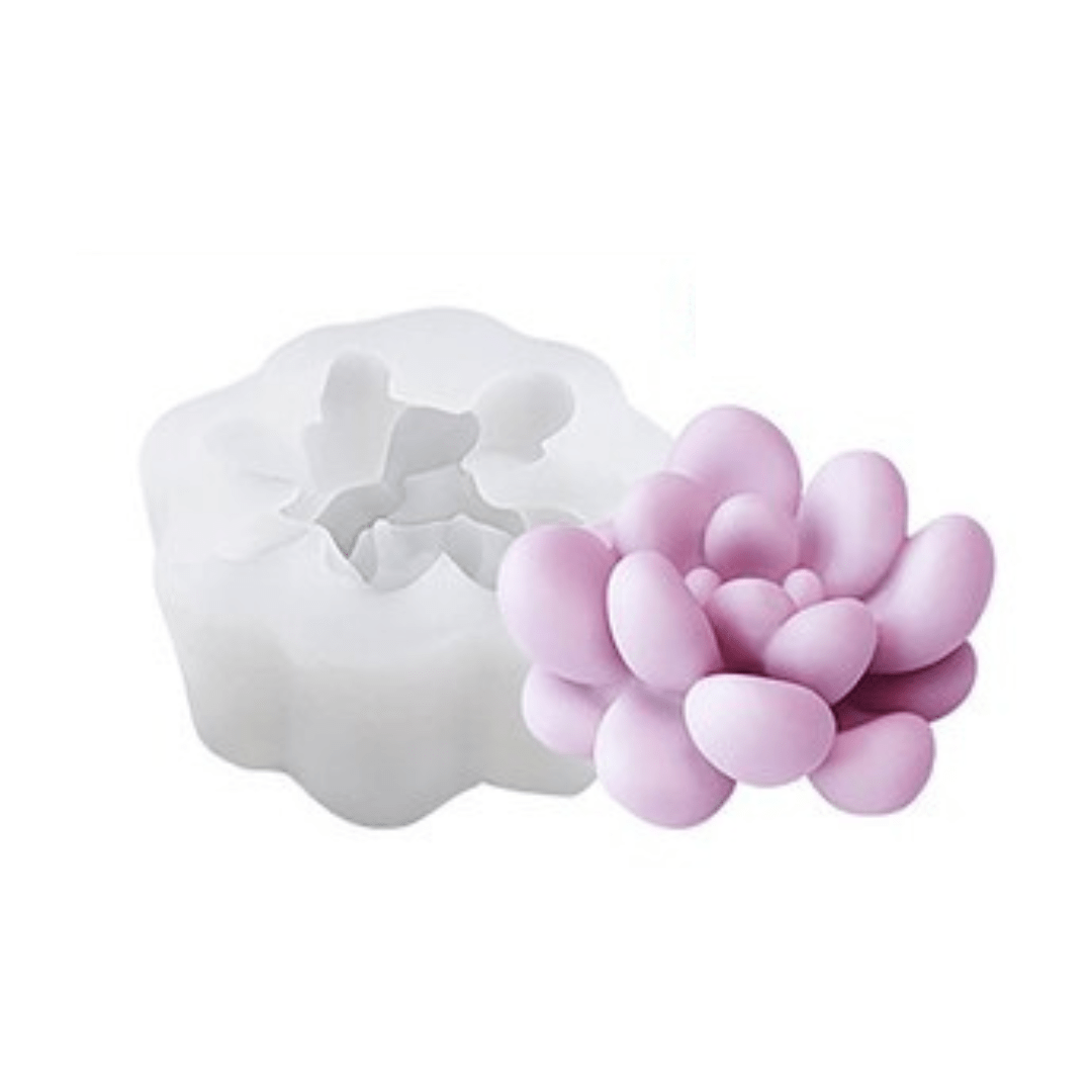 floral succulent mould candle in purple wax next to silicone mould on white background