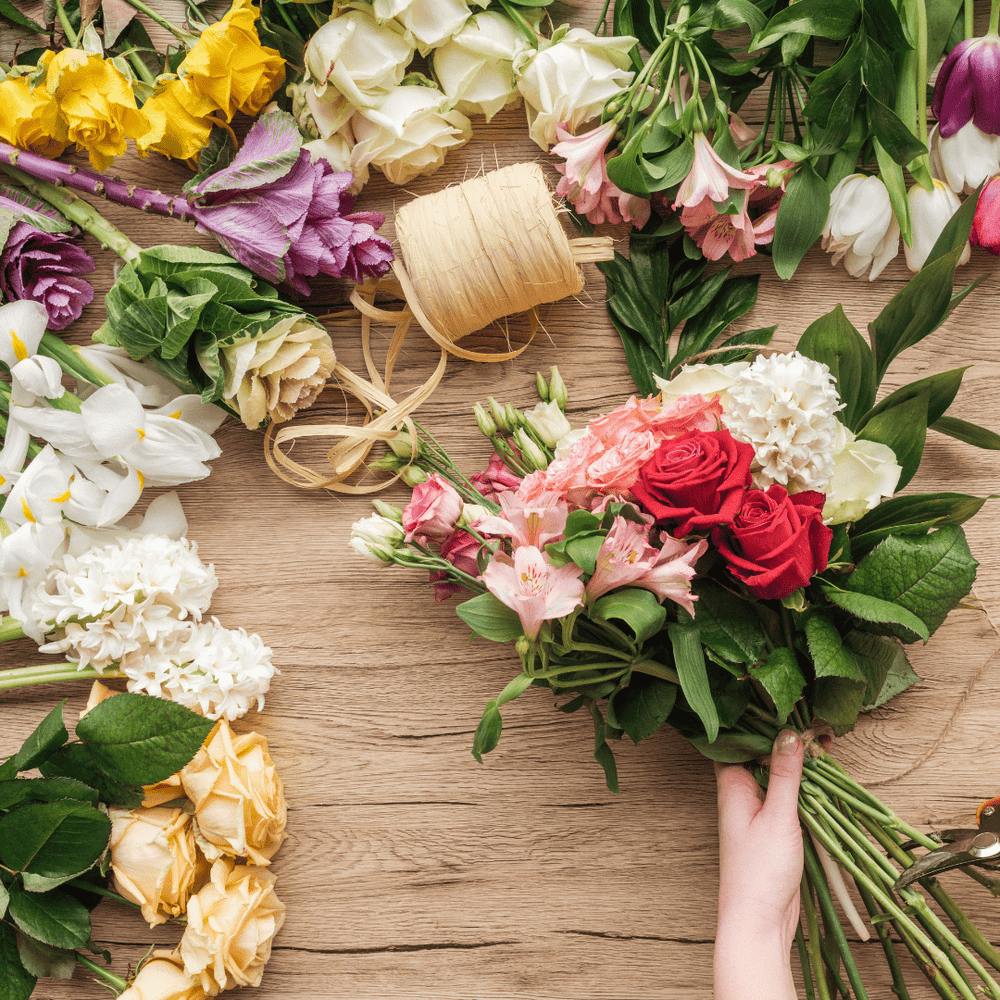 assorted flowers spread out on table