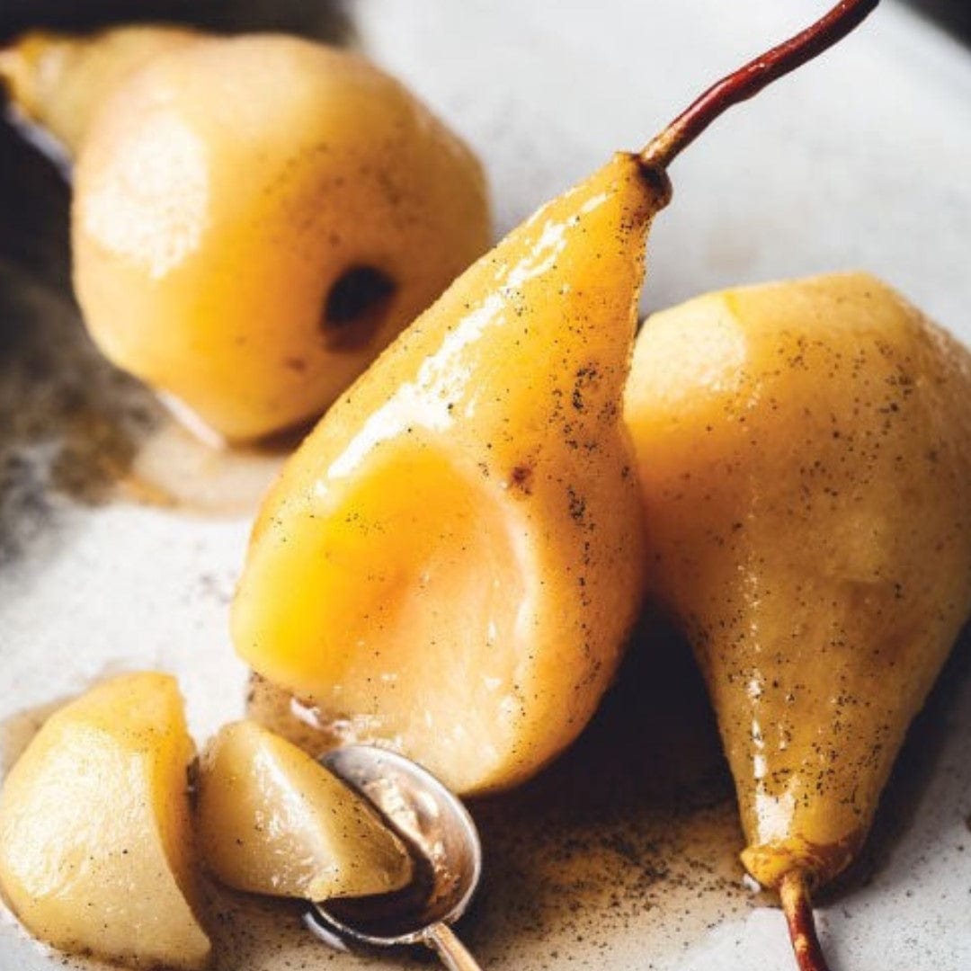 pears sittng in bowl covered with cinnamon & syrup