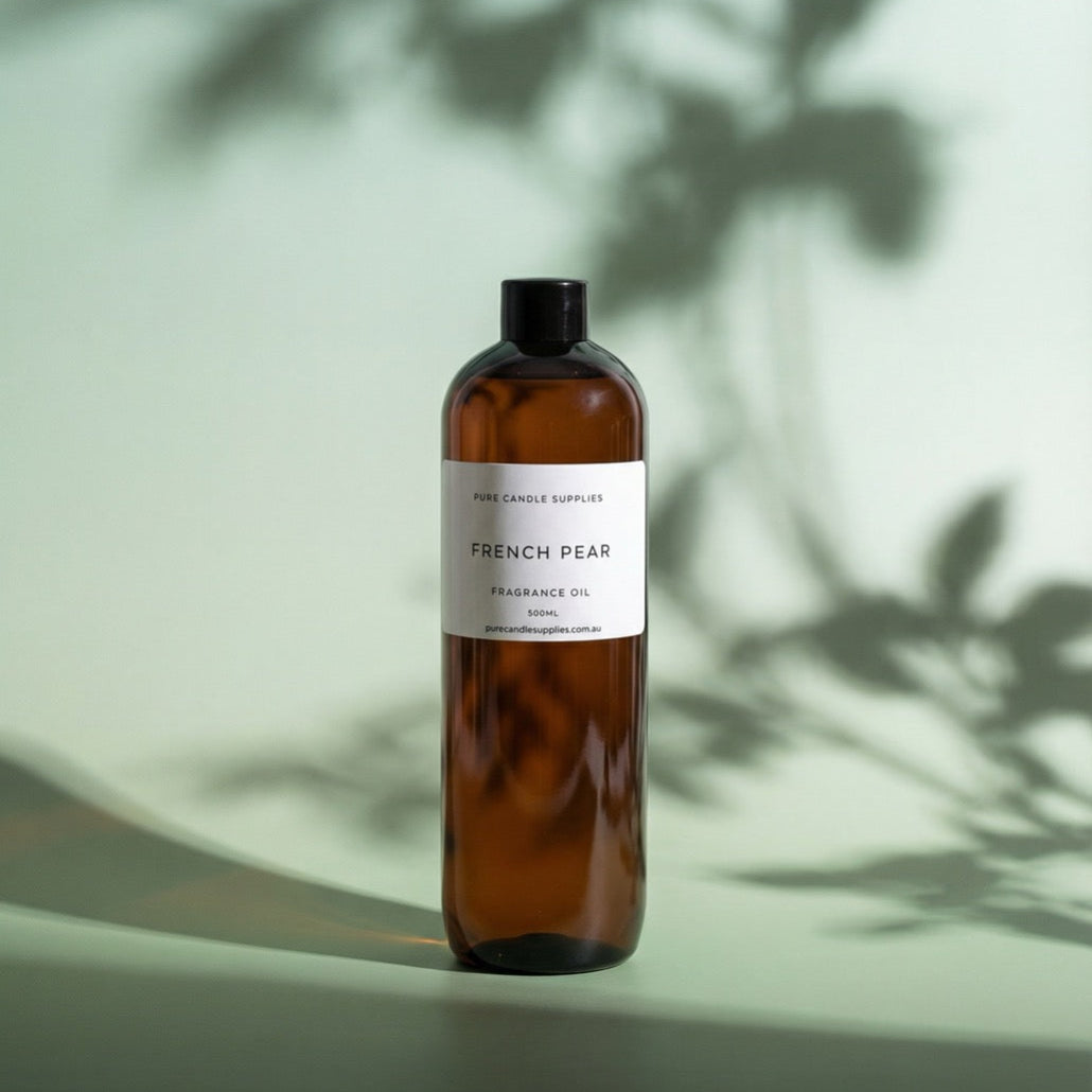 Brown bottle of French Pear fragrance oil with a white label on a light green background