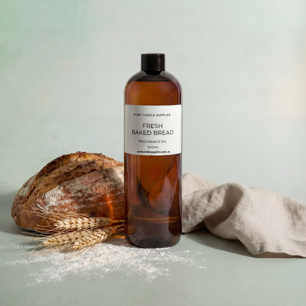 Bottle of 'Fresh Baked Bread' fragrance oil with a loaf of bread and wheat on a light background