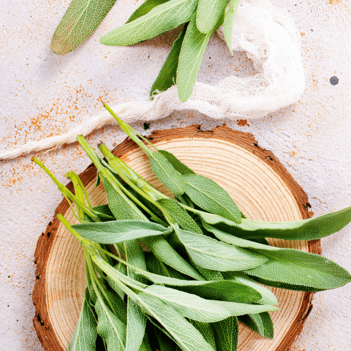 sage leaves resting on wooden round