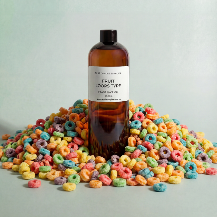 Bottle of 'Fruit Loops Type' fragrance oil surrounded by colorful cereal loops on a light gray background