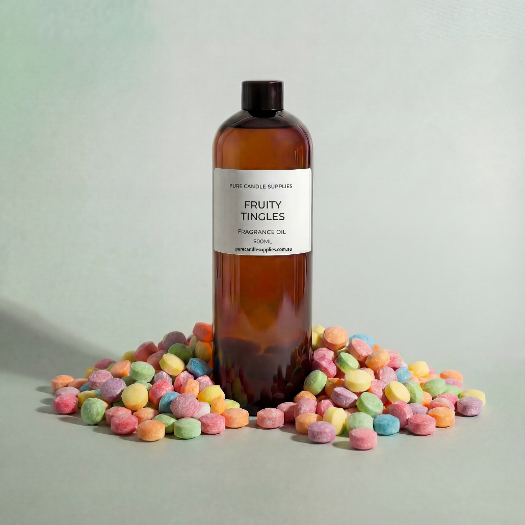 Bottle of 'Fruity Tingles' fragrance oil surrounded by colorful candies on a light background