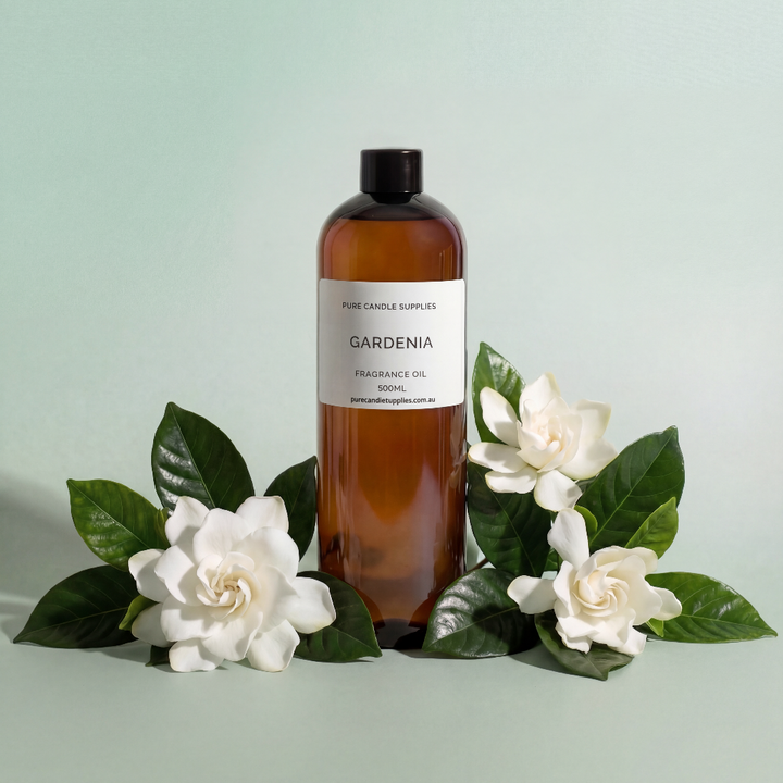Bottle of Gardenia fragrance oil with gardenias on a light green background