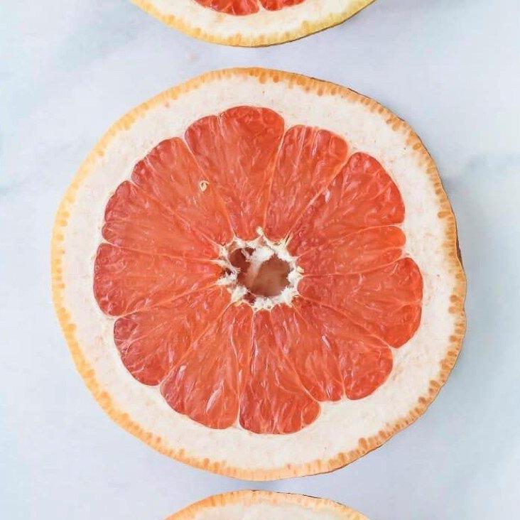 Halved grapefruit on marble background