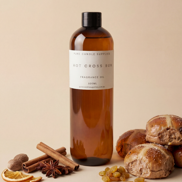 Bottle of Hot Cross Bun fragrance oil with ingredients on a beige background