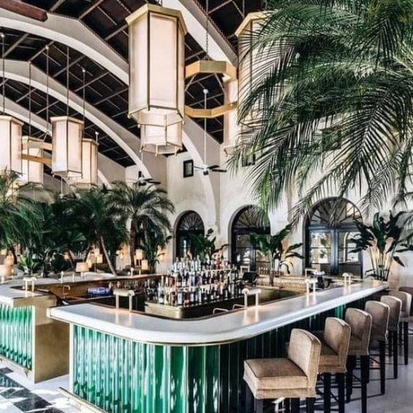 Luxurious Hotel Bar with palm trees and large decorative arch ways