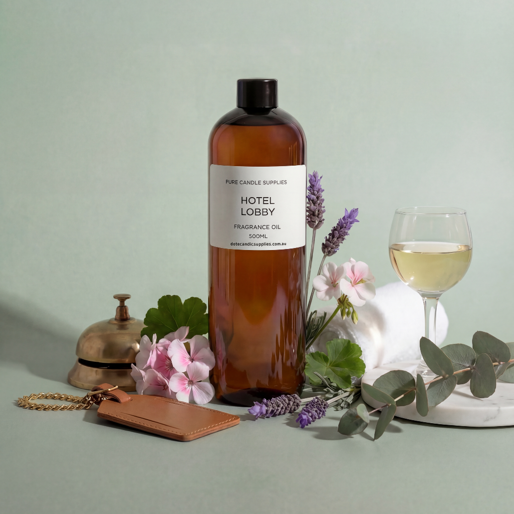 Bottle of 'Hotel Lobby' fragrance oil with decorative items on a light green background