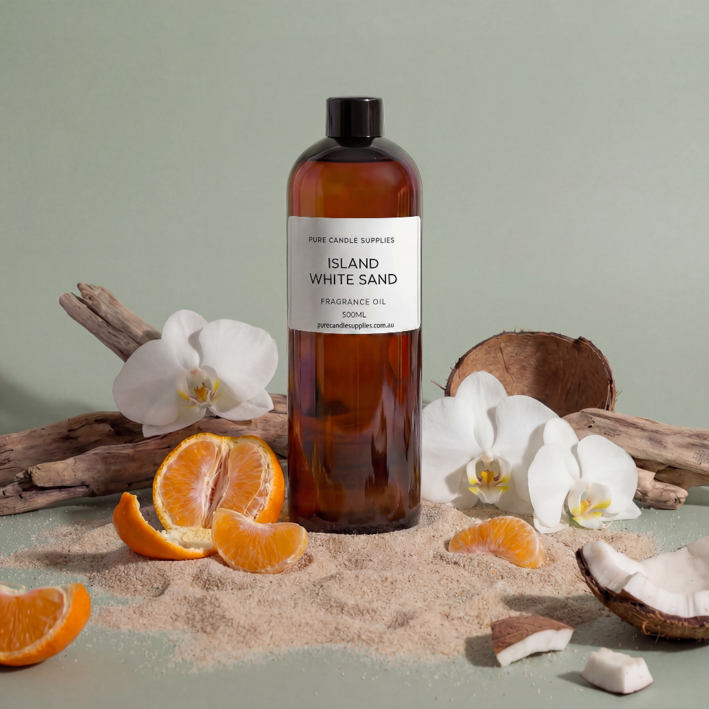 Bottle of 'Island White Sand' fragrance oil with oranges, coconuts, and orchids on a light green background