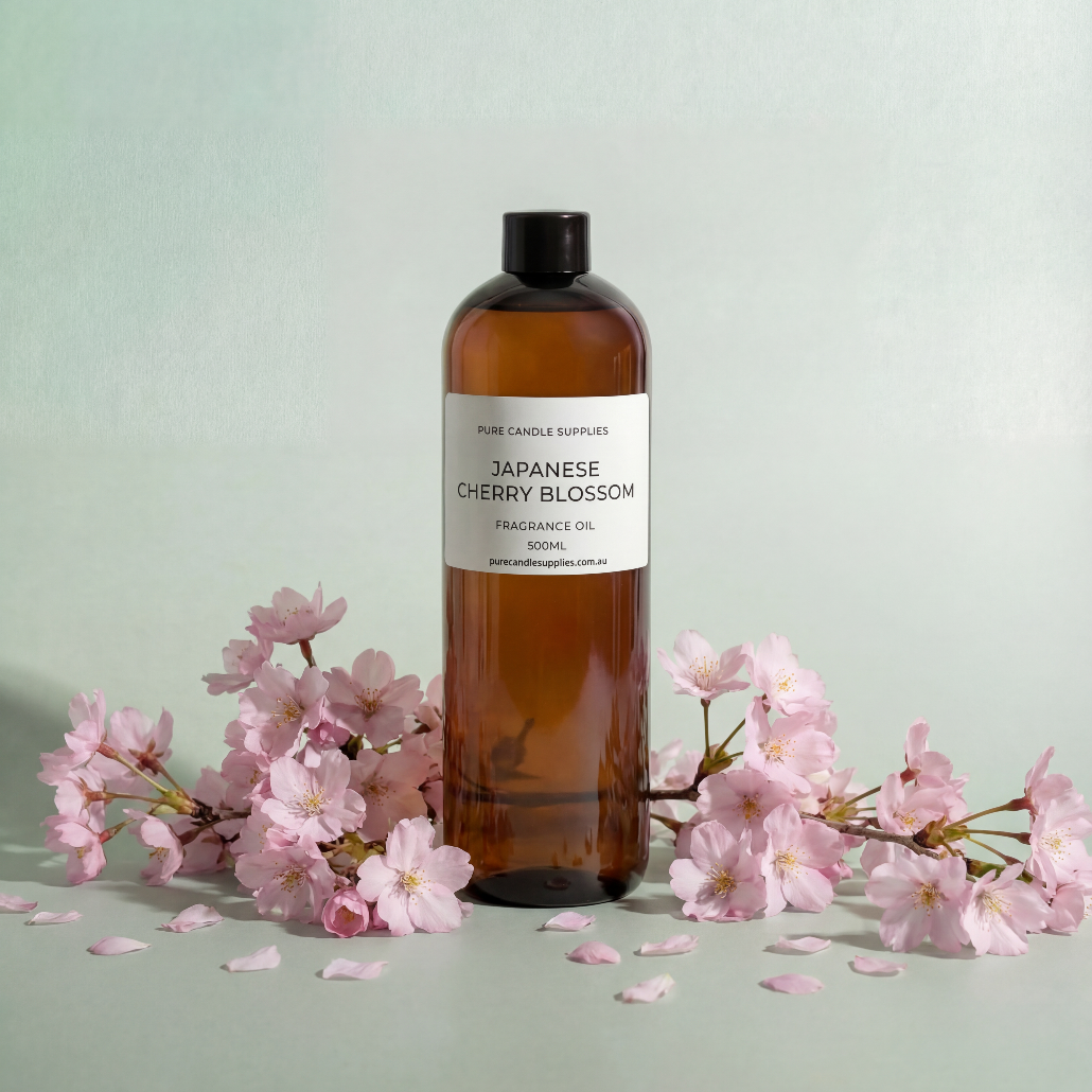 Bottle of Japanese Cherry Blossom fragrance oil with cherry blossoms on a light green background