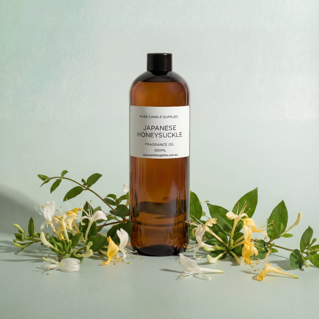 Bottle of Japanese honeysuckle fragrance oil with flowers on a light green background
