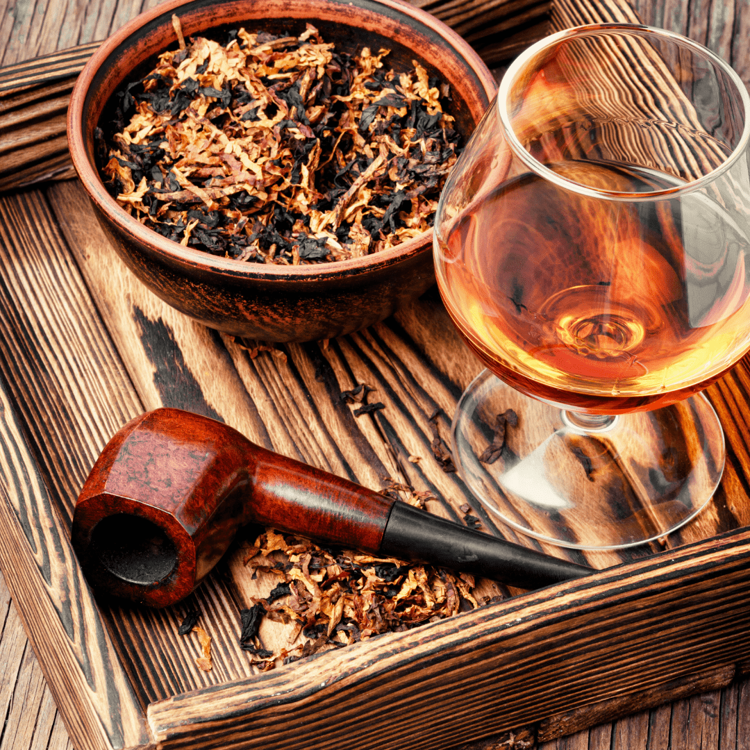 Glass of brandy, with pipe and bowl of tobacco