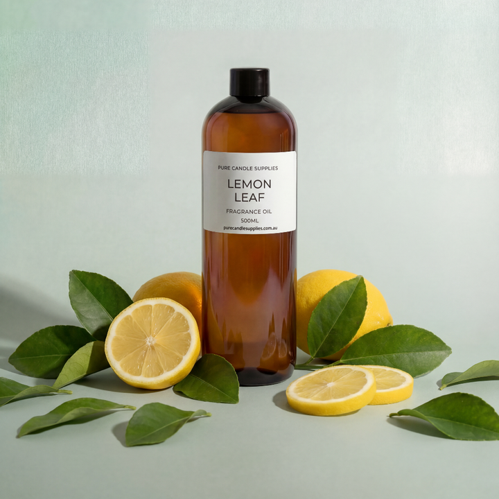 Bottle of lemon leaf fragrance oil with lemons and leaves on a light green background
