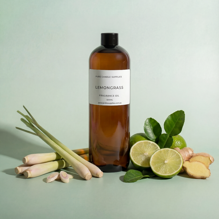 Bottle of lemongrass fragrance oil with lemongrass, limes, and ginger on a light green background