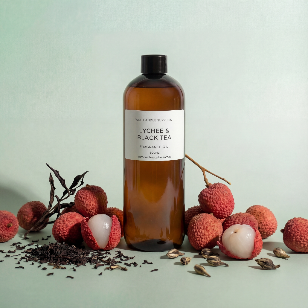 Bottle of lychee and black tea fragrance oil with lychees and tea leaves on a light background