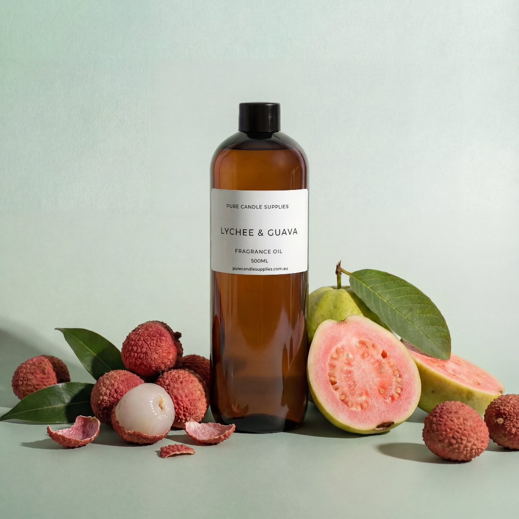 Bottle of Lychee & Guava fragrance oil with lychees and guavas on a light green background