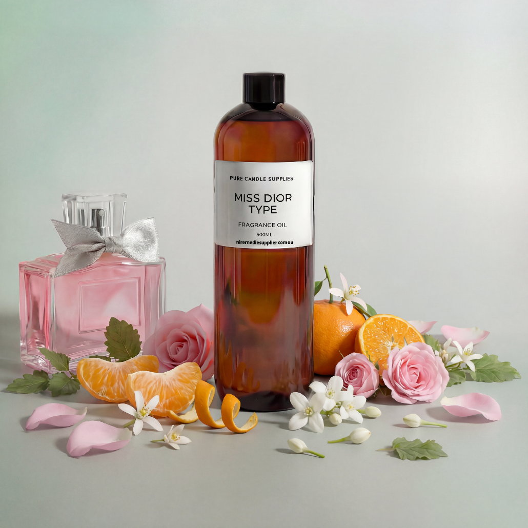 Bottle of 'Miss Dior Type' perfume with pink flowers and oranges on a light gray background