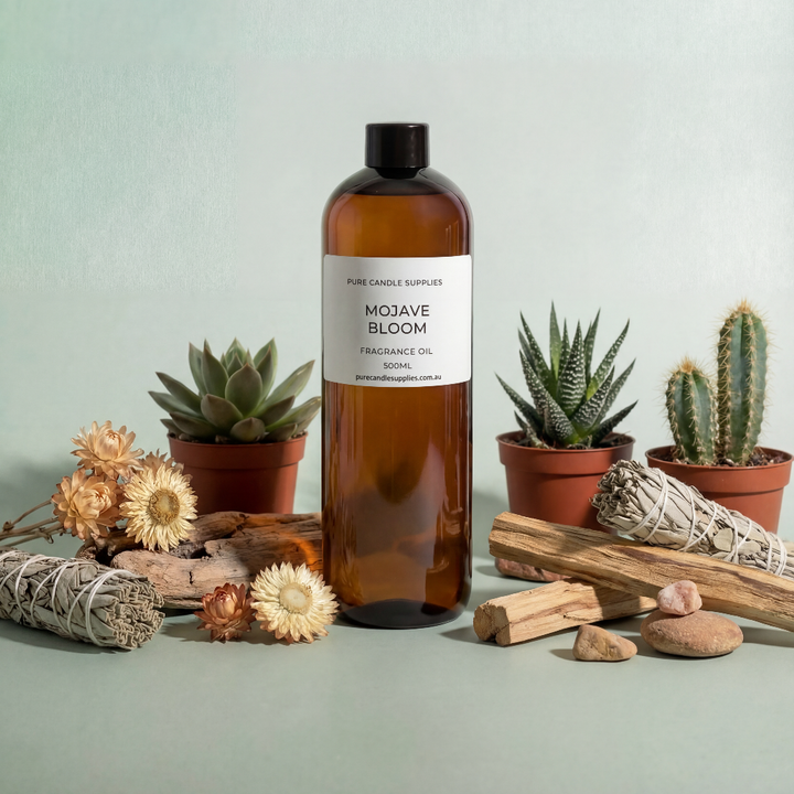 Bottle of Mojave Bloom fragrance oil with cacti and natural elements on a light background