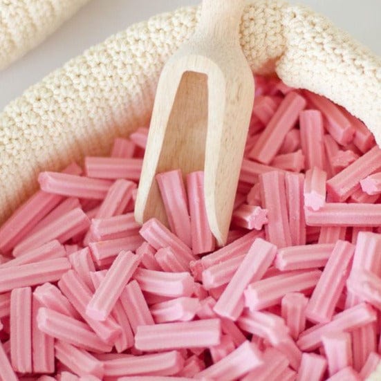 Bowl of musk stick lollies with lolly scoop