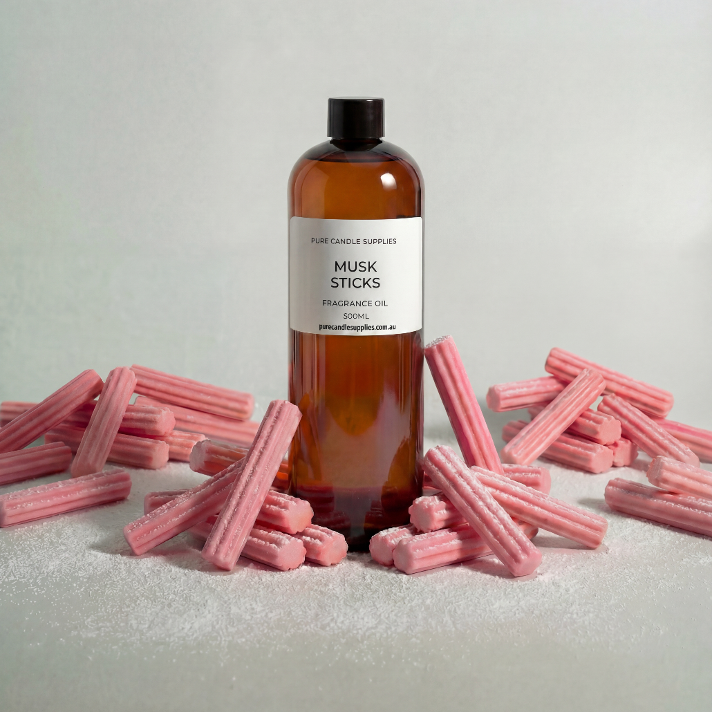 Bottle of Musk Sticks fragrance oil with pink sticks on a light background