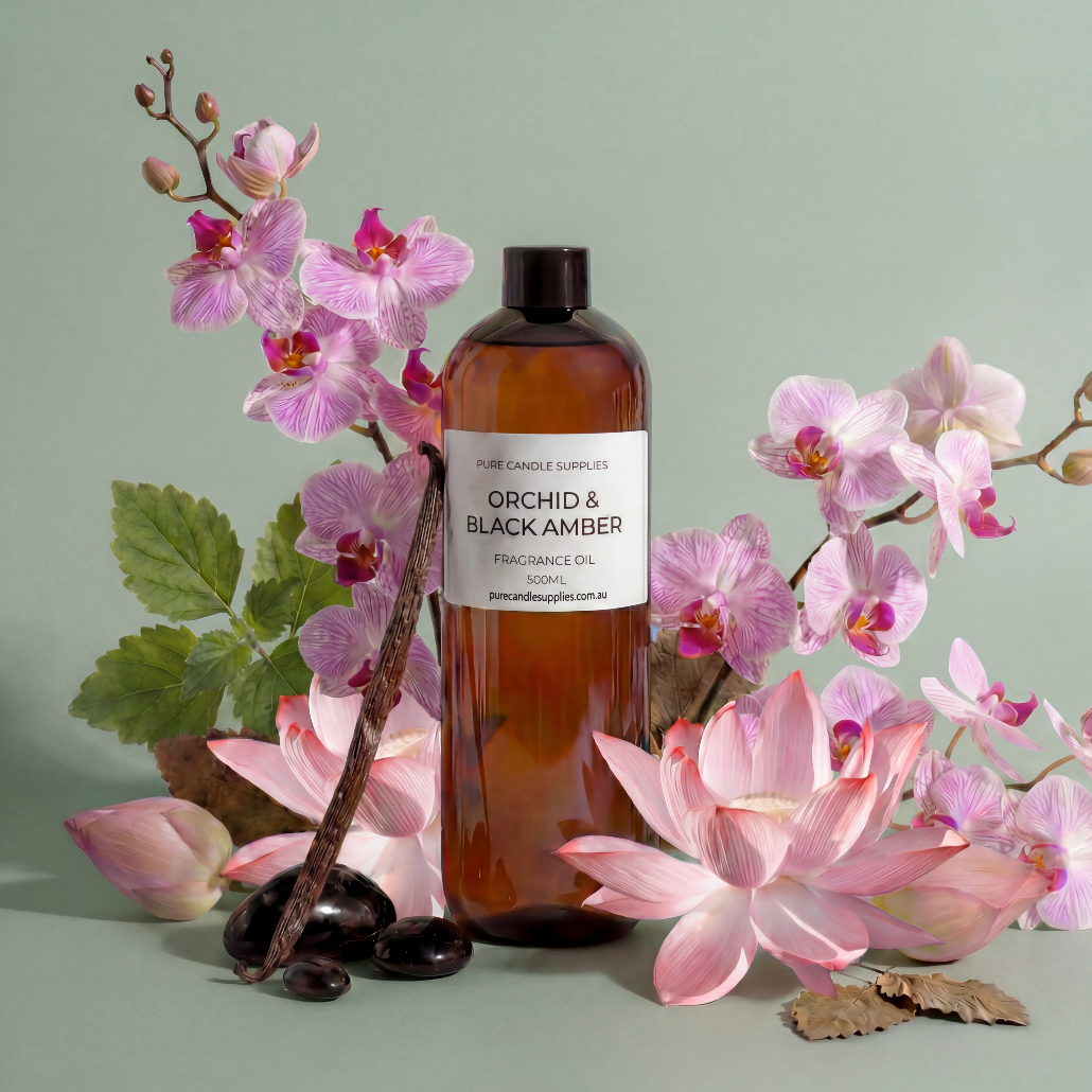 Bottle of orchid and black amber fragrance oil with pink flowers on a light green background