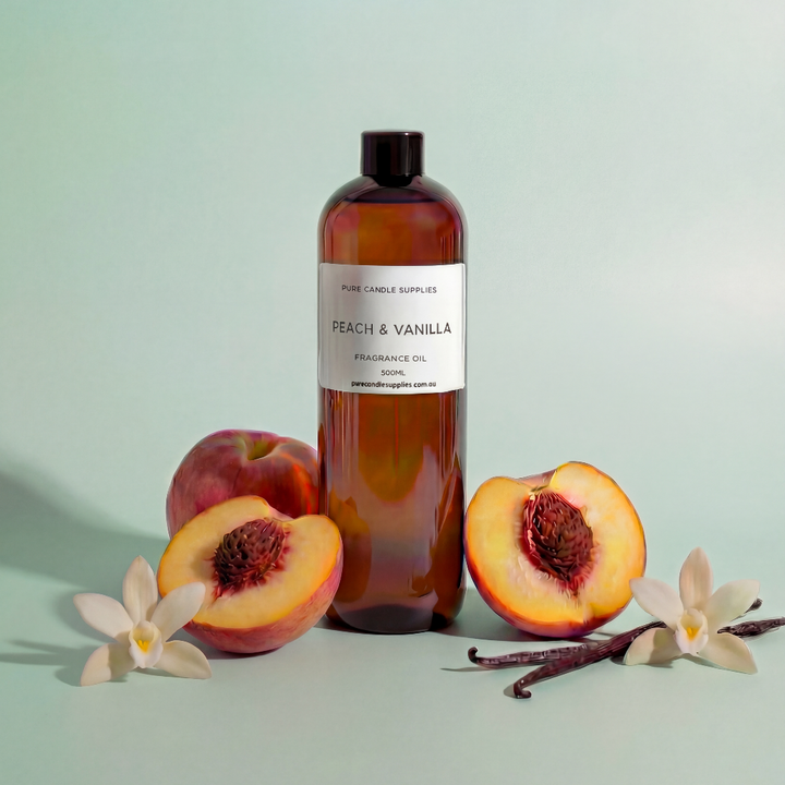 Bottle of peach and vanilla fragrance oil with peaches and vanilla beans on a light green background