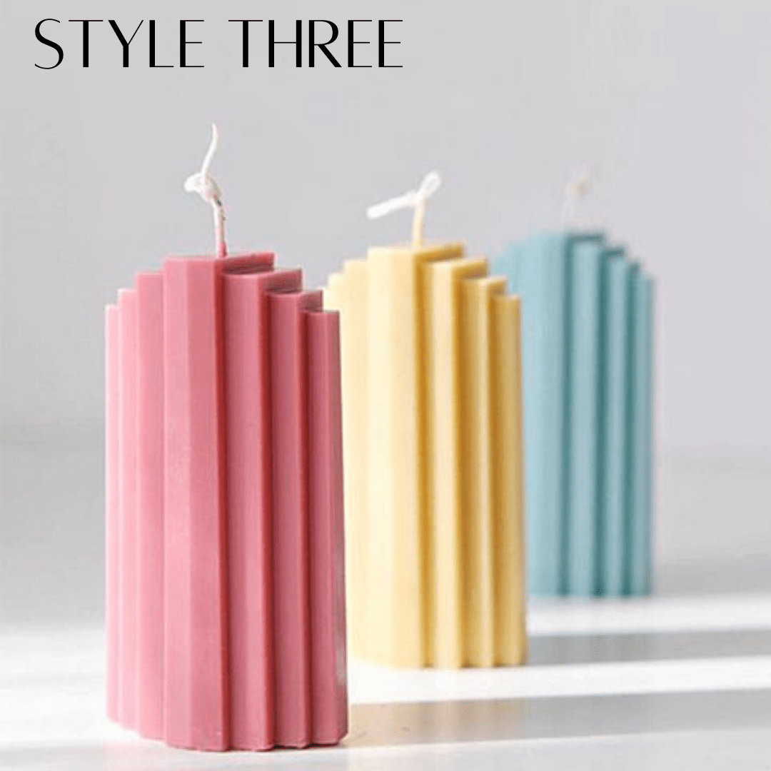 three staircase pillar candles in pink yellow and blue on a white background