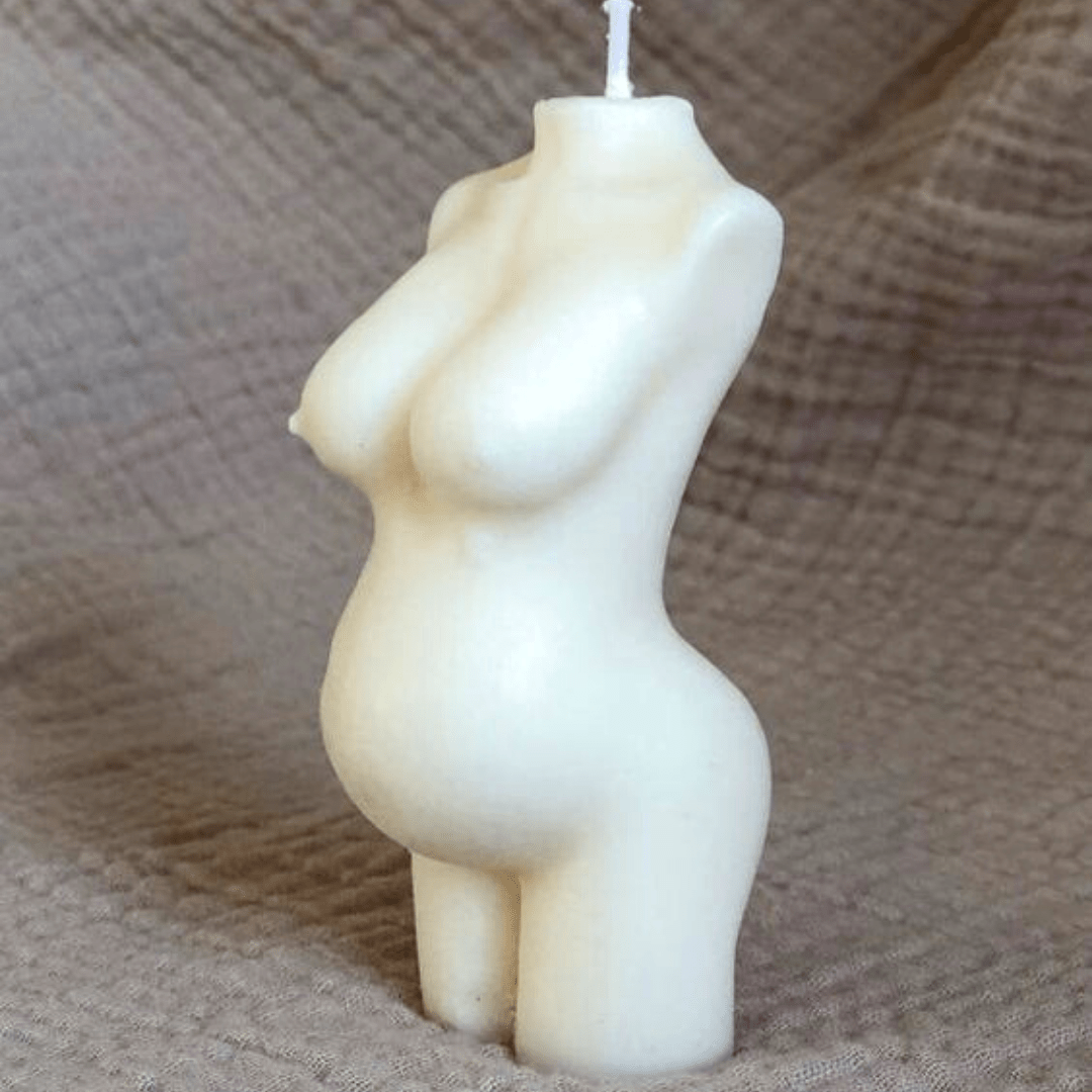 pregnant female body candle on textured brown background