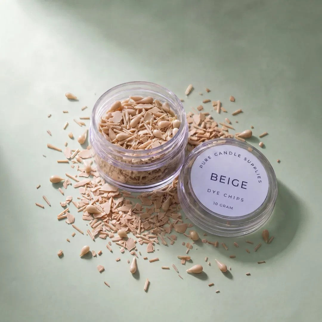 Pure Candle Supplies Melbourne beige dye chips in a small clear jar for candle making on a soft green surface.