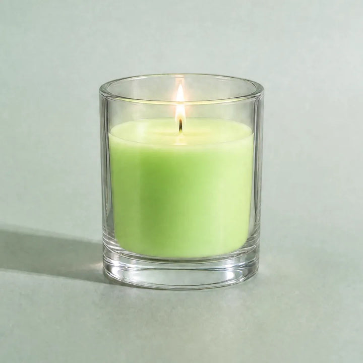 Pure Candle Supplies Melbourne fluro green candle in a clear glass container with a lit wick