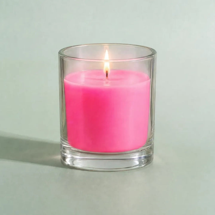 Pure Candle Supplies Melbourne fluro pink candle dye chip result in a clear glass container with a lit wick