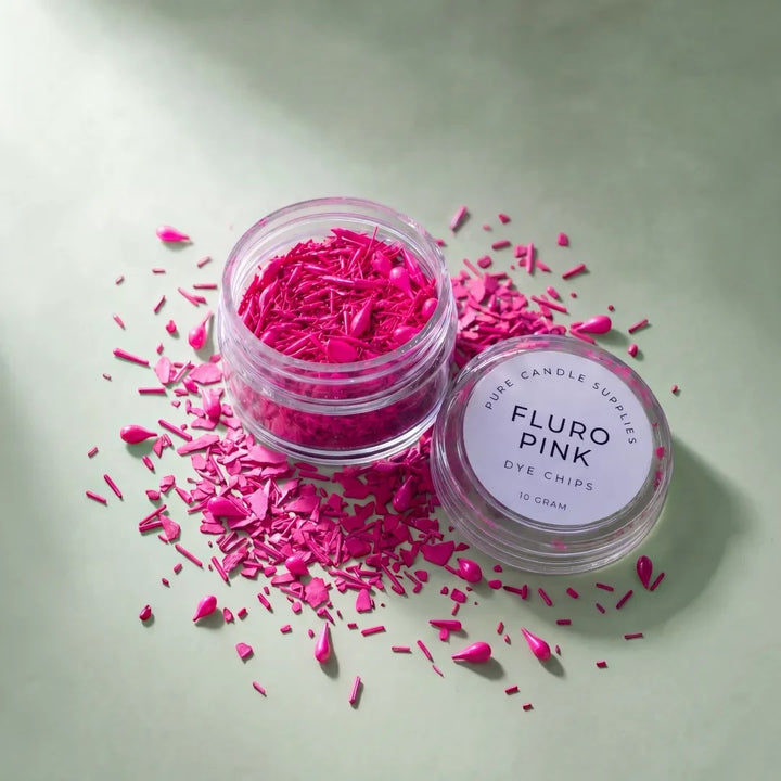 Pure Candle Supplies Melbourne fluro pink candle dye chips in a small clear jar on a soft green background.