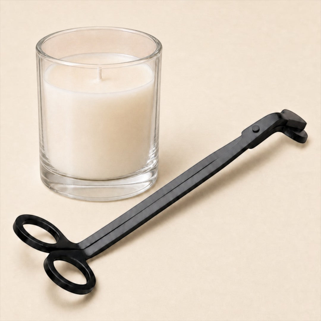 Pure Candle Supplies Melbourne matte black stainless steel wick trimmer next to a glass candle on a beige surface