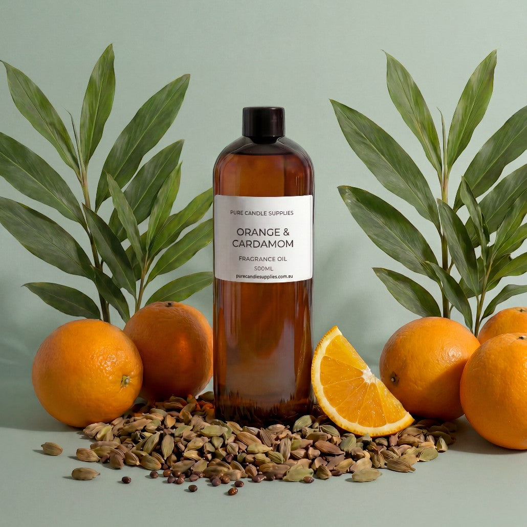 Pure Candle Supplies Melbourne Orange and Cardamom natural fragrance oil in an amber bottle with fresh oranges and spices