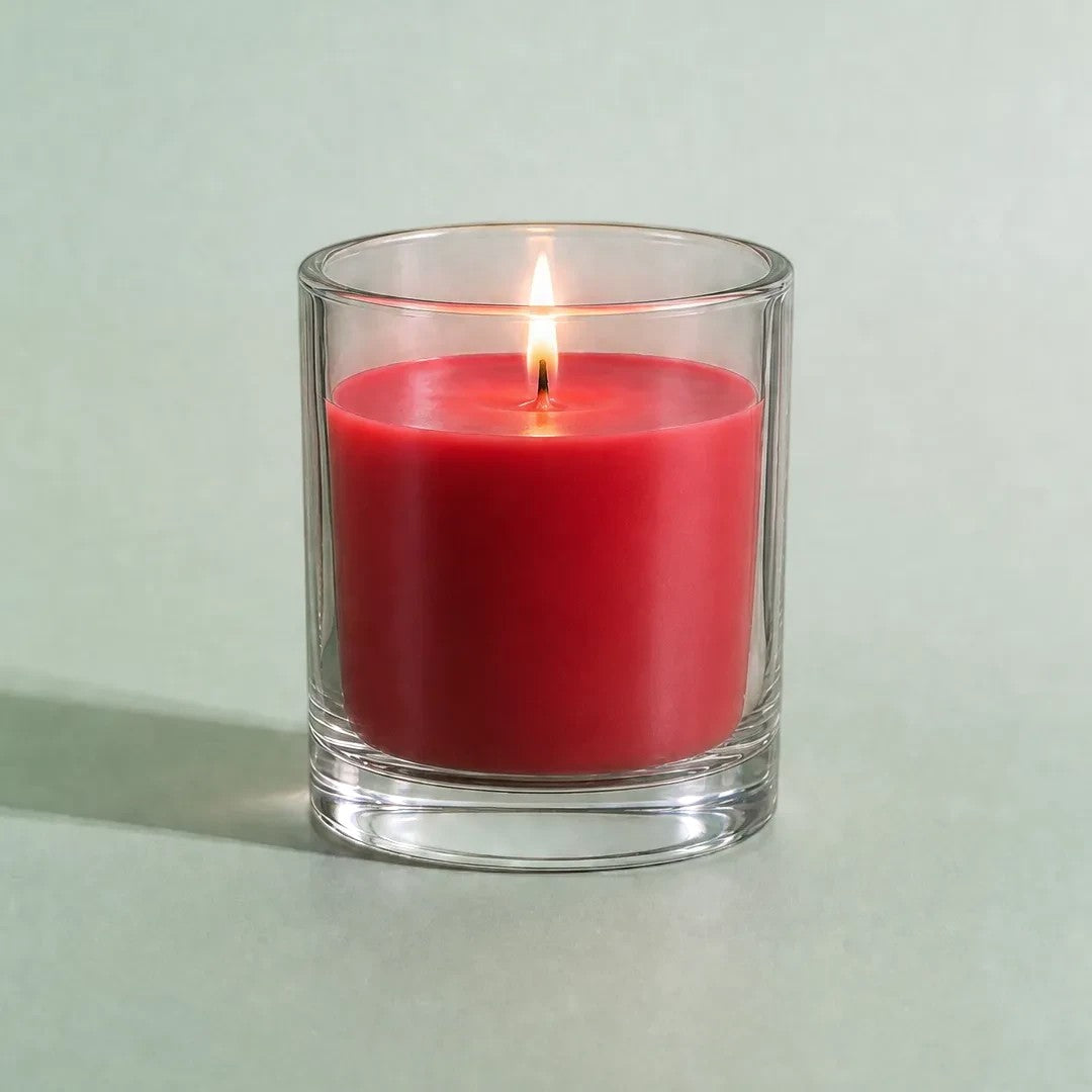 Pure Candle Supplies Melbourne red candle dye chip result in a clear glass container with a lit wick