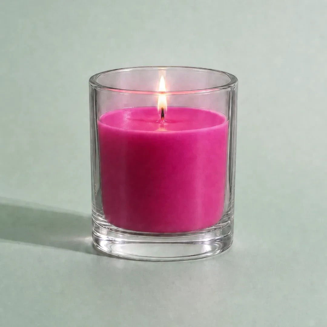 Pure Candle Supplies Melbourne rose dye chip result in a lit glass container candle with vibrant pink wax