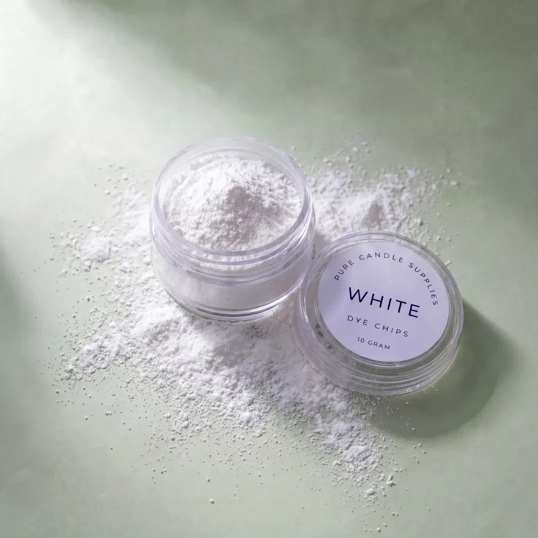 Pure Candle Supplies Melbourne white powdered candle dye in a small clear jar with a matching lid on a green surface.