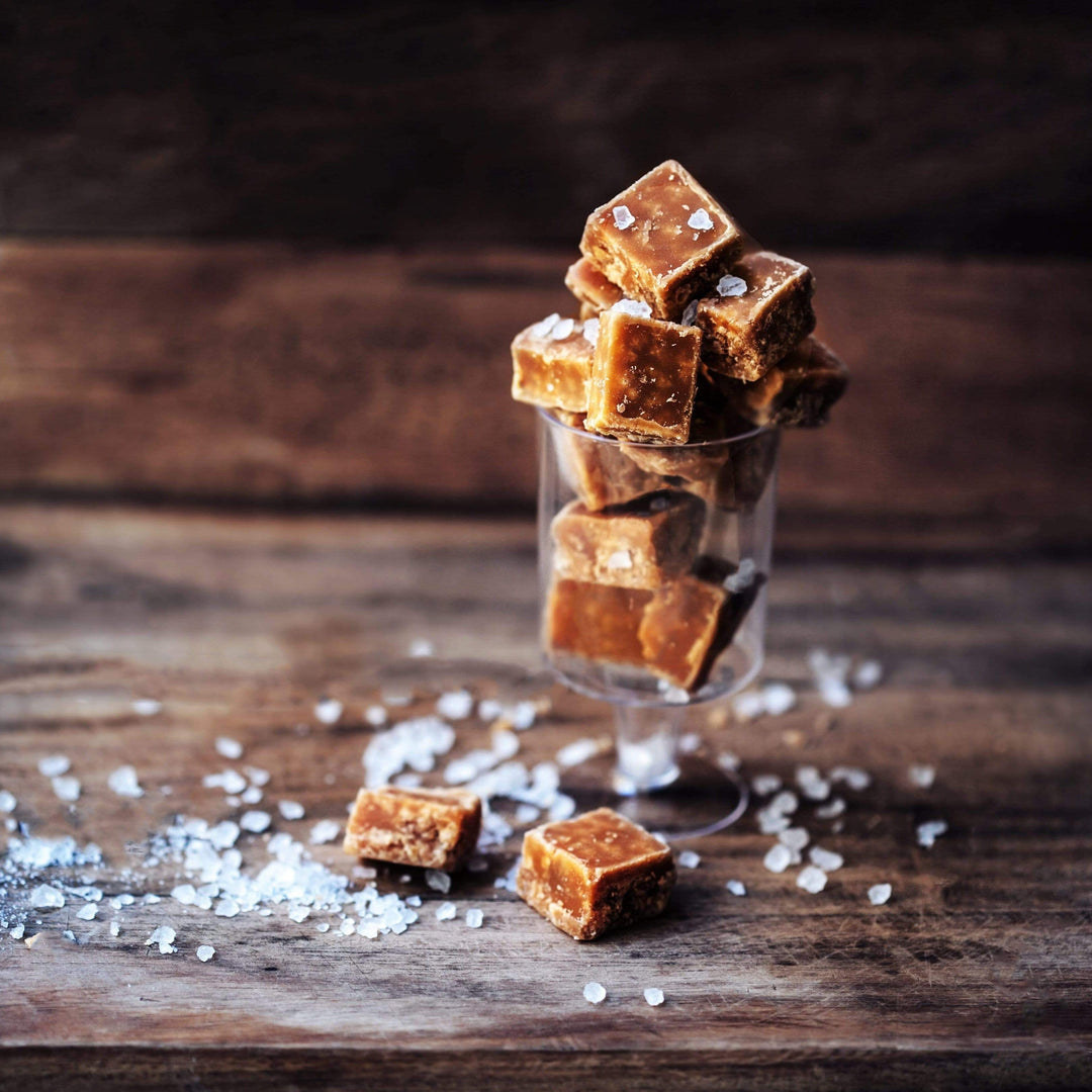 salted caramel fudge cubes, layered in plastic cup with salt scattered around
