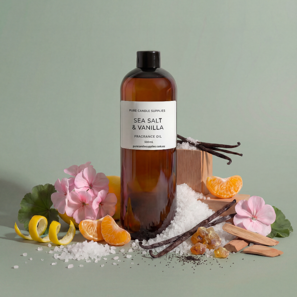 Bottle of sea salt and vanilla fragrance oil with floral and citrus elements on a light green background