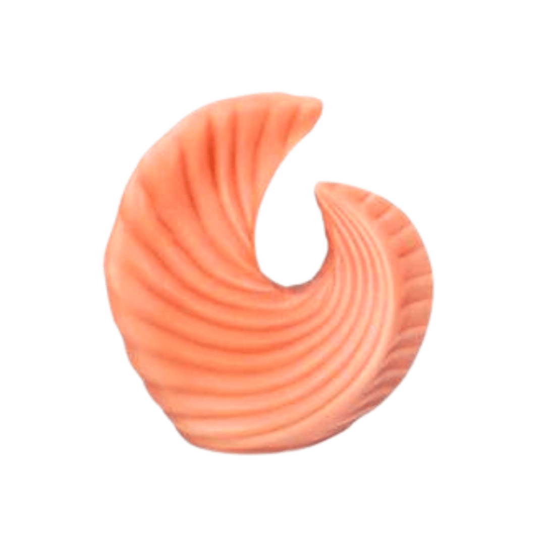 sea shell shaped candle in orange wax on a white background