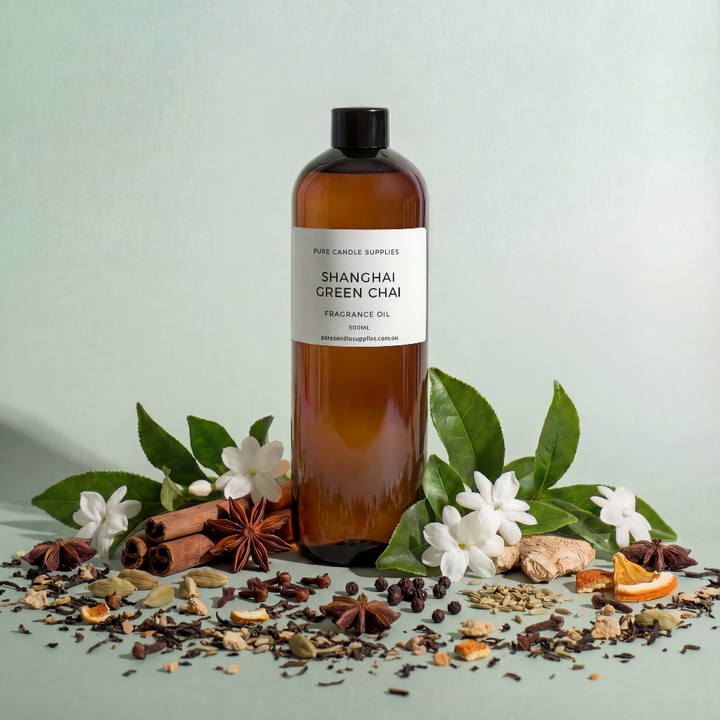 Bottle of Shangri-La Green Chai fragrance oil with botanical elements on a light green background