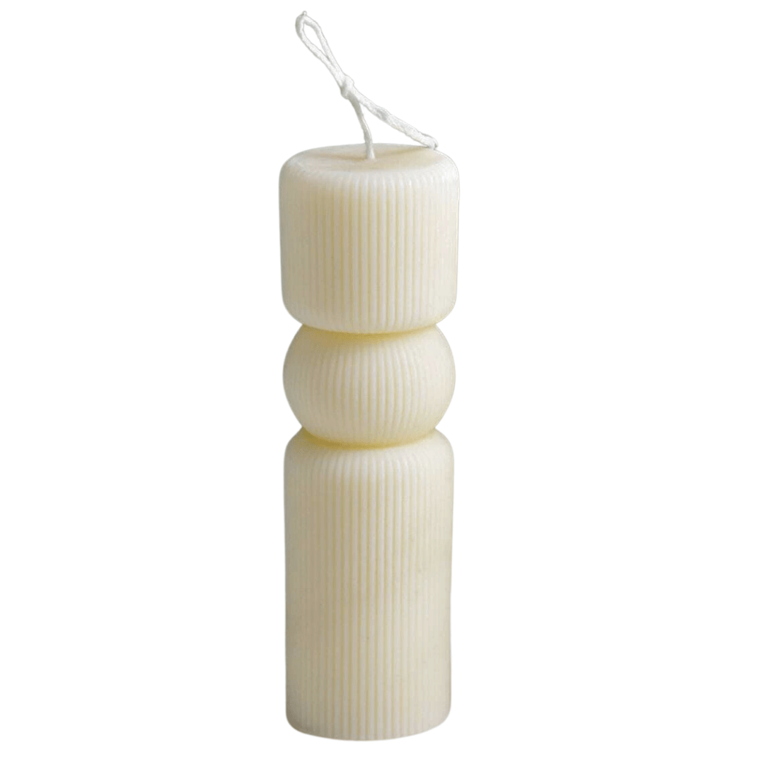 spherical shaped candle with ribbed sides in creamy white wax against white background