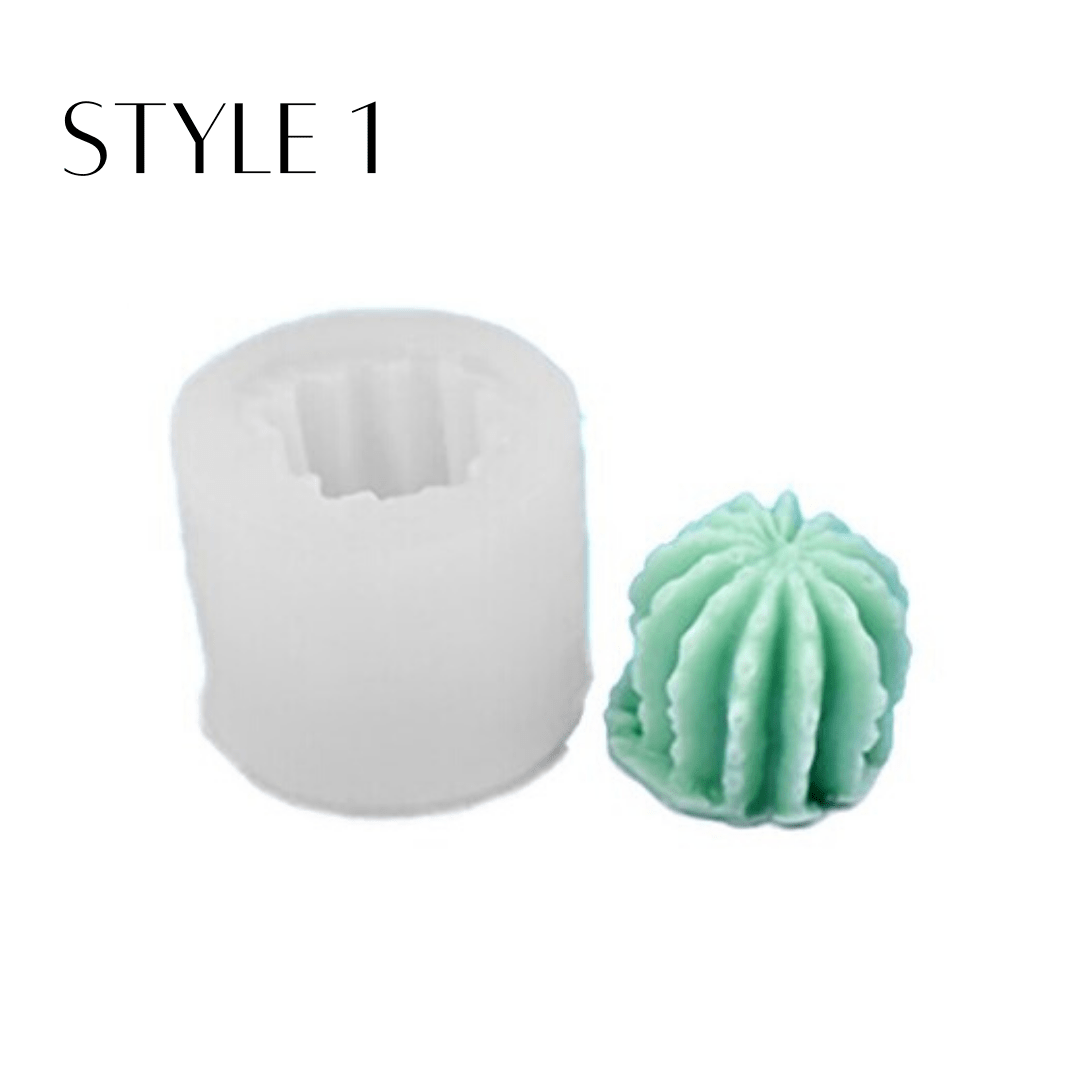 succulent shaped candle in green wax next to silicone mould on white background